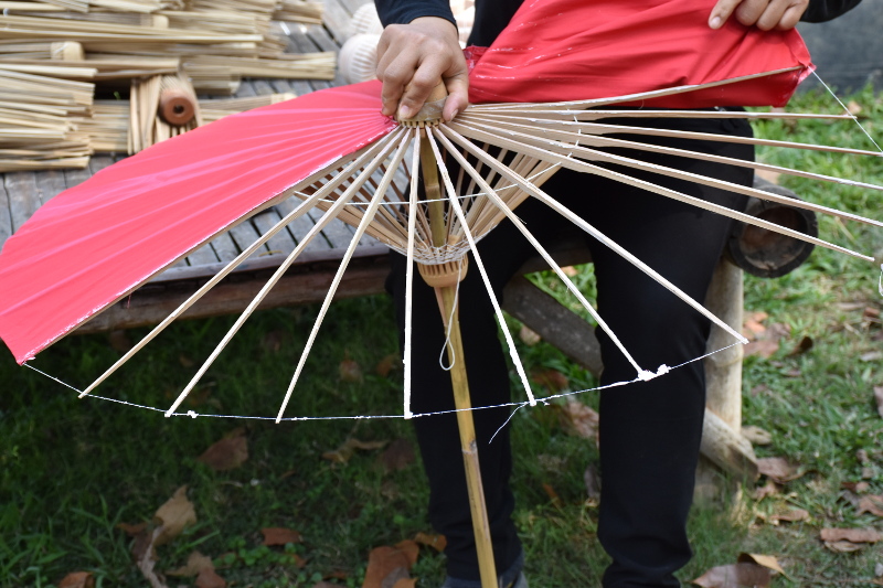 Removing a bamboo umbrella's fabric canopy for replacement