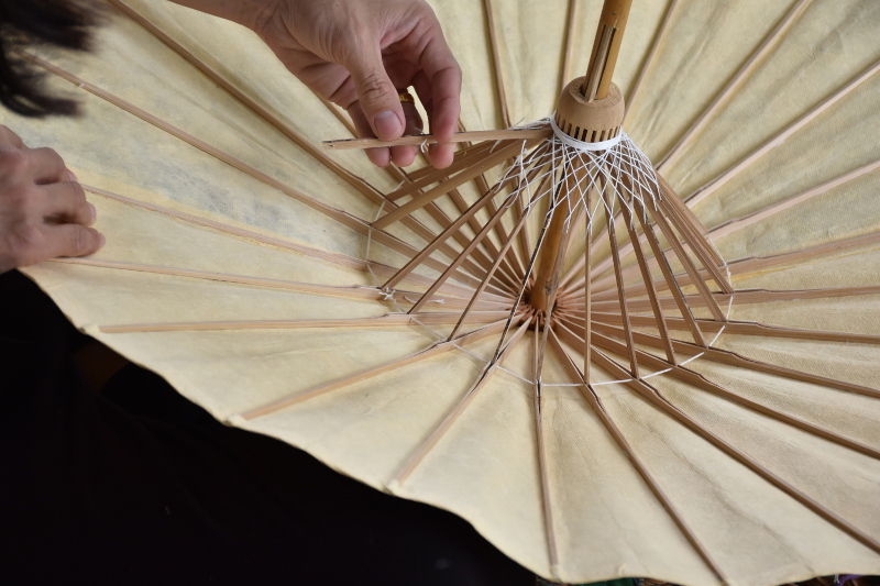 Removing a bamboo umbrella's broken support rib for replacement
